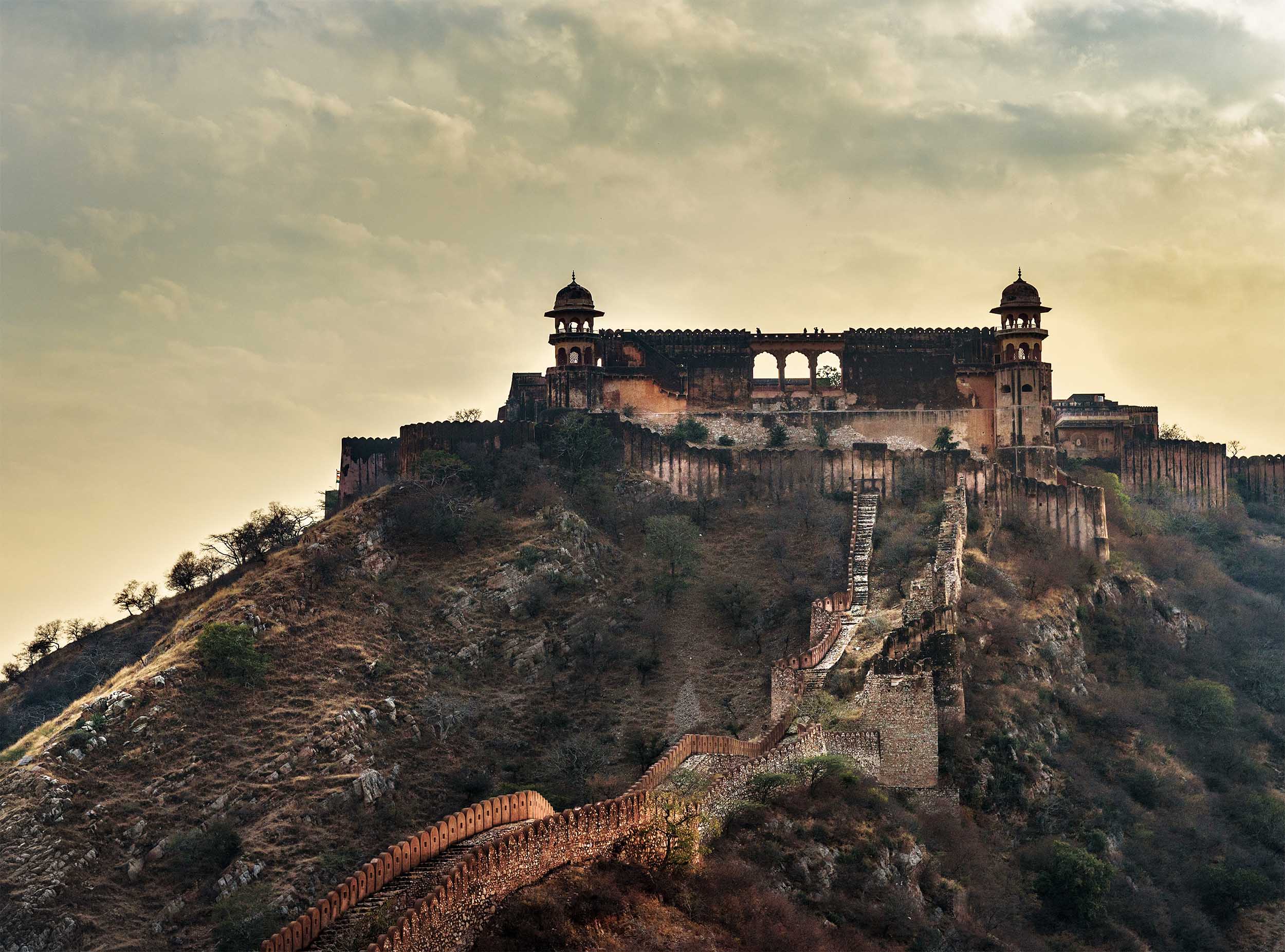 A view of Jaigarh Fort's Southern Reservoir, surrounded by rugged terrain and historic fortification walls.