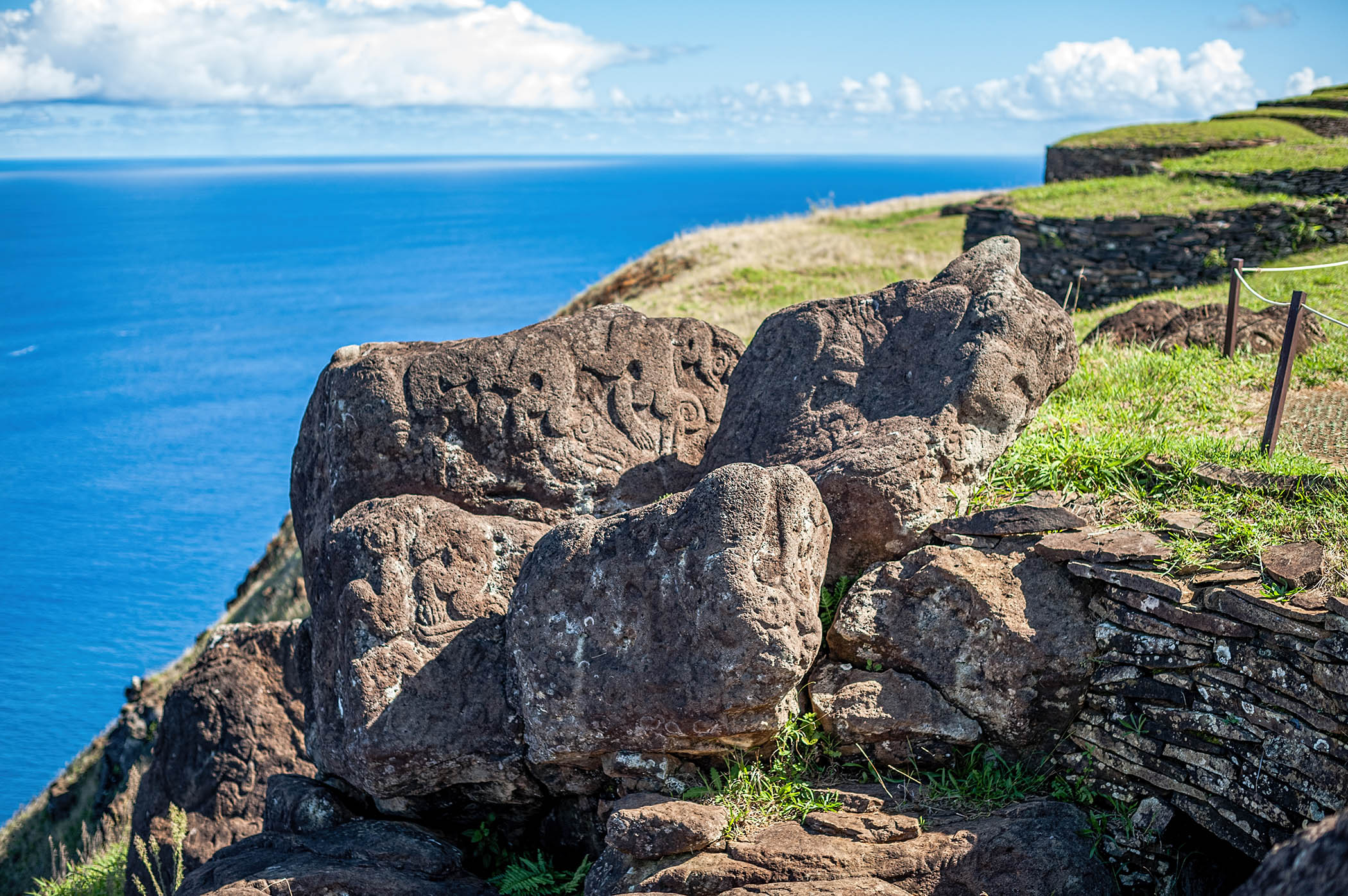 Photo showing petroglyphs of Mata Ŋā Rahu. THe lighting coming from an angle makes the reliefs visible. 
    